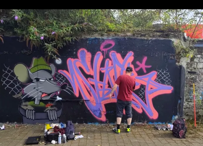 Character wall and pink graffiti